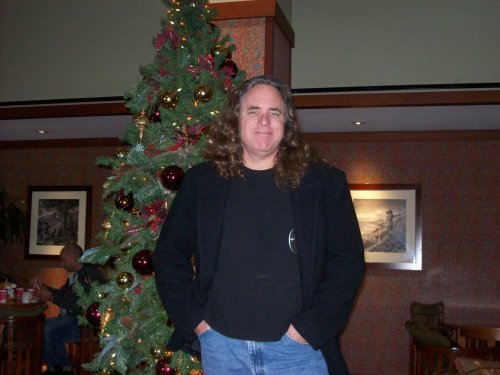 Jon in front of Christmas tree in concierge lounge 