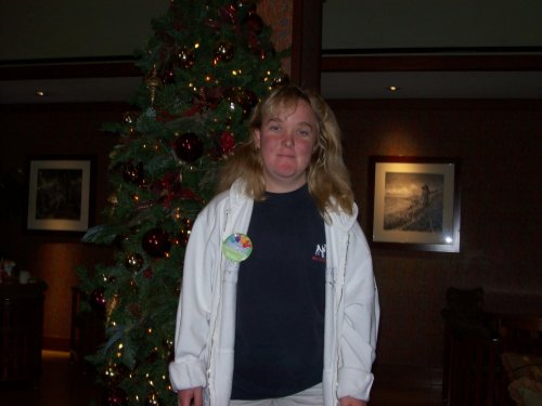 Missy in front of Christmas tree in concierge lounge 