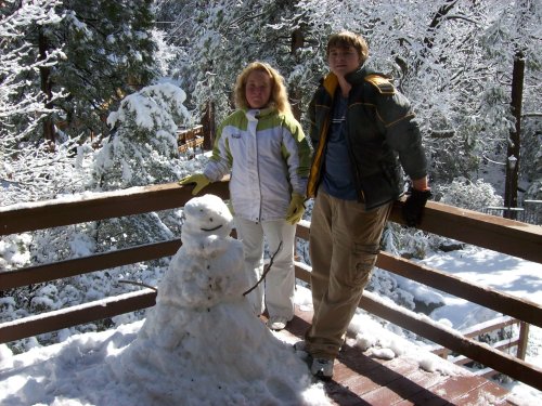 Kids with snowman on the deck 