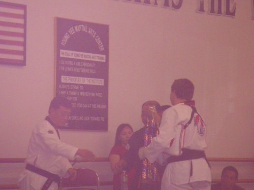 Jonny accepting trophy after passing 2nd Degree Black Belt test 