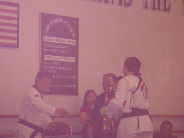 Jonny accepting trophy after passing 2nd Degree Black Belt test 