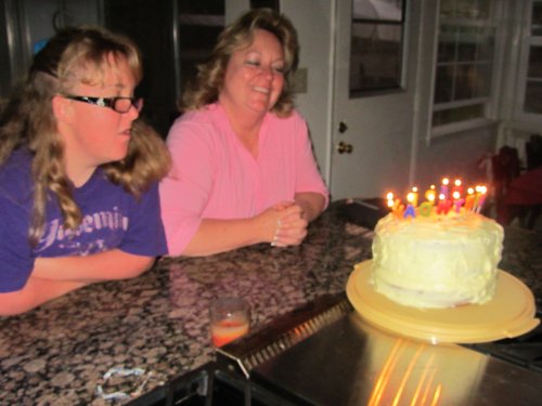 Melissa helping mom blow out candles 