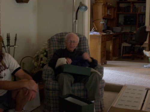 Grandpa opening presents at his birthday party 