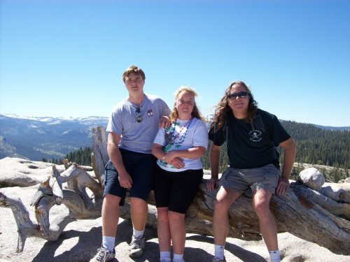 Dad and kids on Jeffrey Pine log 