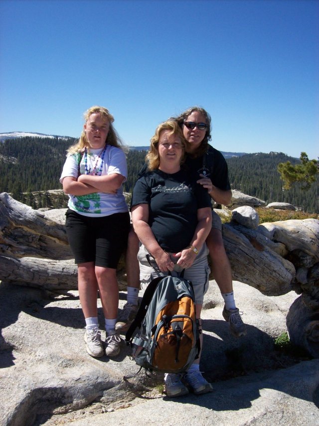 Mom, dad and Melissa on Jeffrey Pine log 