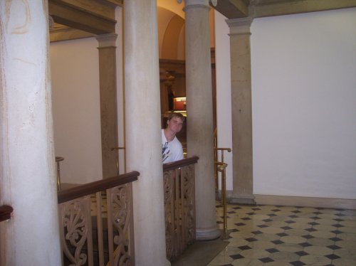 Jonny peering around column 