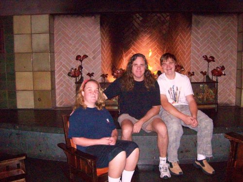 Melissa, Jon & Jonny in front of fireplace in lobby at Grand Californian 