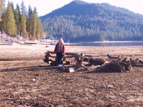 Melissa and logs in lakebed near Fall's Beach 