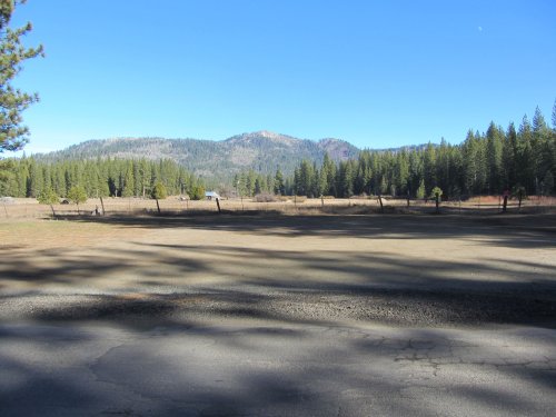 Meadow and old buildings in high country 