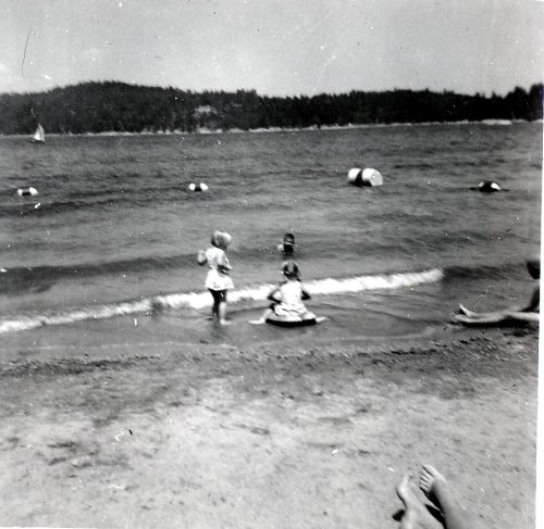 Kids swim near dock 
